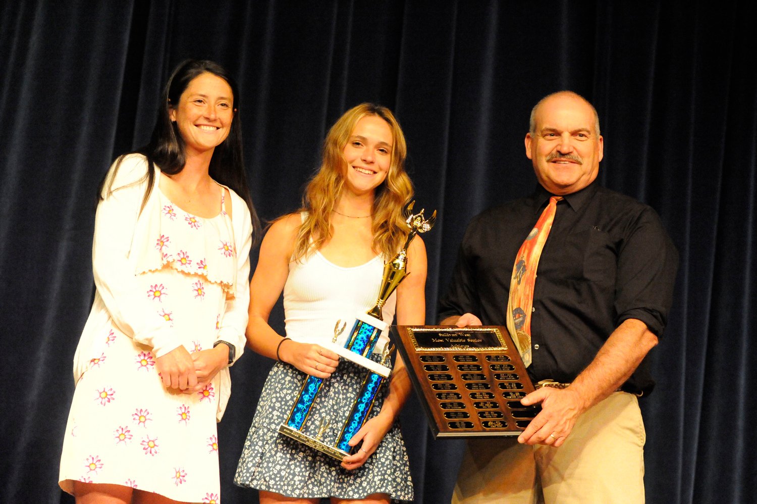 Grace Boyd, Sullivan West’s 2021-2022 Most Valuable Female Senior Athlete is joined on stage by her coaches, Skylar Musa (speaker) and Anthony Durkin (presenter)...